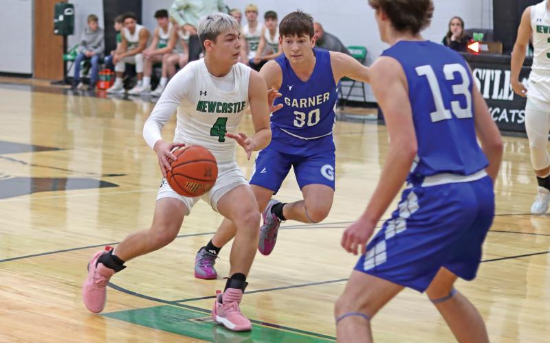 (THOMAS WALLNER | THE GRAHAM LEADER) Rylan Hinojosa pushes past Garner defenders during an aggressive game Tuesday, Jan. 14 which resulted in a 46-26 win. The Bobcats managed to push far ahead near the end of the game to secure the win.