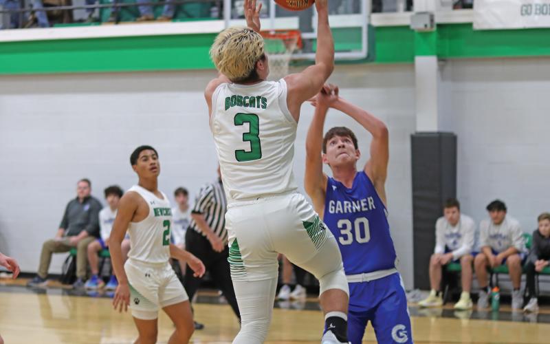 (THOMAS WALLNER | THE GRAHAM LEADER) Keyton Newland jumps to make a 2-point shot over Garner players who put up an aggressive defense all game. Newland was a powerhouse on the court and helped lead the Bobcats to victory Tuesday, Jan. 14.