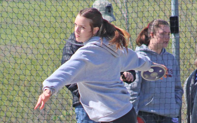 (TC GORDON | THE GRAHAM LEADER) Lillian Noble moves her momentum forward before launching a discus throw during one of the track and field meets earlier this season. The Steers and Lady Blues recently competed at the Col Mobley Optimist Relays in Stephenville last Thursday, March 28.