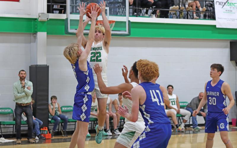 (THOMAS WALLNER | THE GRAHAM LEADER) Ryan Holden jumps to make a shot near the 3-point line for the Bobcats during their matchup Tuesday, Jan. 15. The team kept the lead for the majority of the game, but the Garner defense put up an aggressive front.