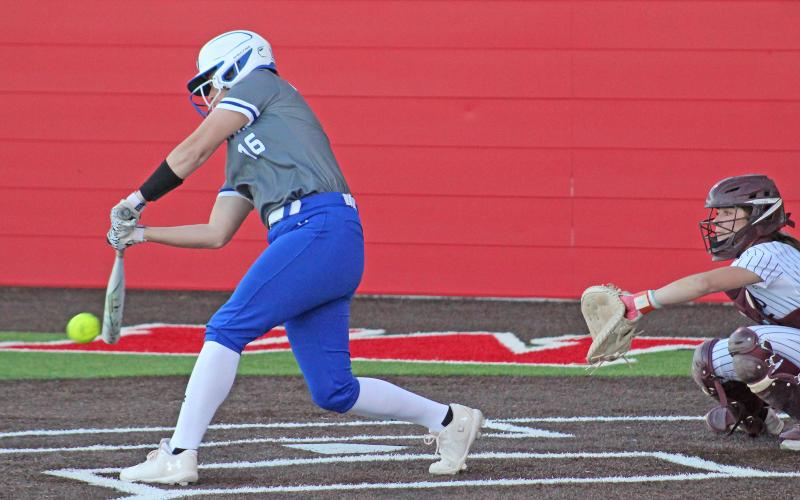 (TC GORDON | THE GRAHAM LEADER) Graham’s Peyton Dobbs makes hard contact with a pitch during her at bat in the Lady Blues’ game against Brownwood. The Lady Blues beat the Lady Lions 12-0 this past Monday, March 25.