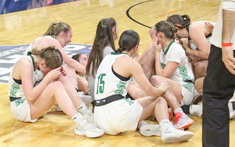 (TC GORDON | THE GRAHAM LEADER) The Newcastle Ladycats mob each other and celebrate on the floor after the final buzzer sounded in the state championship title game. The Ladycats defeated Turkey Valley 48-32 to claim the Class 1A state title, the first in Newcastle’s history.