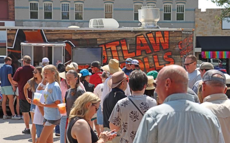 (ARCHIVE PHOTO | THE GRAHAM LEADER) Visitors line up at the Outlaw Eggrolls food truck in 2024 during the Food Truck Championship of Texas of the Graham downtown square.