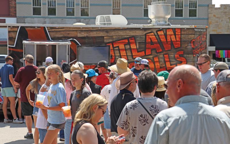 (THOMAS WALLNER | THE GRAHAM LEADER) Visitors to the Food Truck Championship of Texas which in line for a bite to eat. The food truck competition is one of the largest events put on by the Visit Graham organizations, which had their budget approved this week by the Graham City Council.