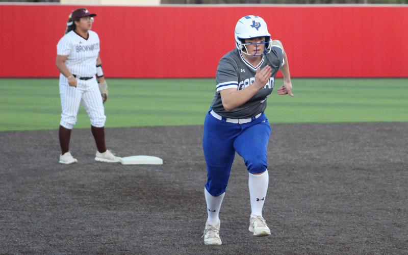 (TC GORDON | THE GRAHAM LEADER) Meagan Brooks makes a break for third base when one of her teammates put a ball in play during the Lady Blues’ 12-0 win over Brownwood this past Monday, March 25.