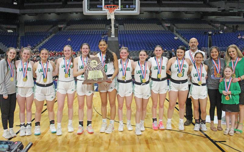 (ARCHIVE PHOTO | THE GRAHAM LEADER) The Newcastle Ladycats stand with their Class 1A state championship trophy Saturday, March 2 after they defeated the Turkey Valley Lady Patriots 48-32 to claim the title.