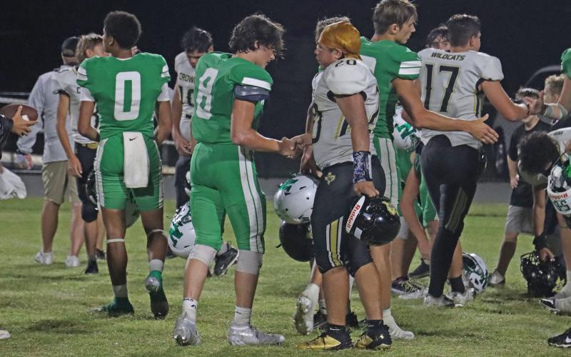 (THOMAS WALLNER | THE GRAHAM LEADER) Peyton King (8), along with his Newcastle teammates, shake hands with Crowell players after beating them Friday, Sept. 5.