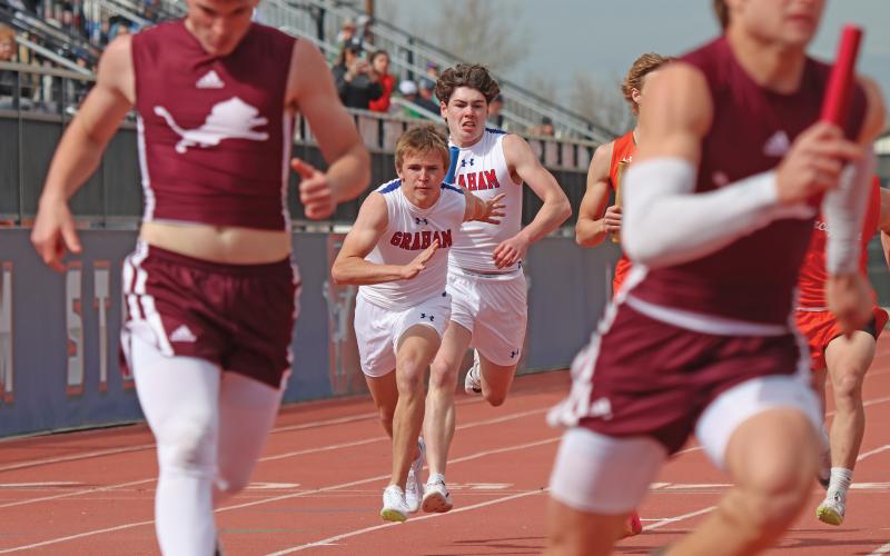 (THOMAS WALLNER | THE GRAHAM LEADER) Macre Menard hands off the baton to Parker Hale during the 4x100 Meter Relay event at the PK Relays held Saturday, March 15. Both athletes were part of the teams for the 4x100 Meter Relay and 4x200 Meter Relay.