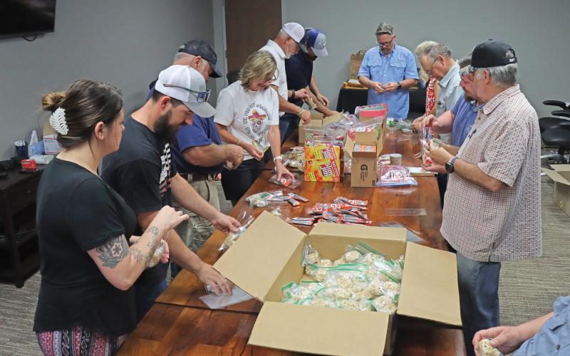 (THOMAS WALLNER | THE GRAHAM LEADER) Volunteers and members of American Legion Post 34 make care packages for U.S. Marines in four locations across the globe. Some the locations the care packages will be sent include Japan and Spain.