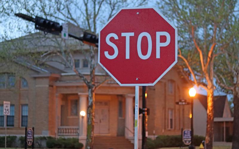 (THOMAS WALLNER | THE GRAHAM LEADER) A temporary stop sign placed Thursday, April 3 at the intersection of Elm Street and Second Street due to the streetlights being out. Power outages occurred across the city of Graham due to severe weather that blew through the area early in the morning.