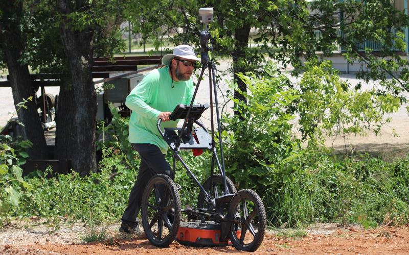 (ALEX HAVARDANSKY | THE GRAHAM LEADER) A ground penetrating radar survey is conducted Monday, July 14 by Dan Kieninger with Texas Cemetery Restoration at the Oak Grove Colored-William P. Johnston Cemetery. Shown is Kieninger pushing a GPR cart in an area behind the cemetery.