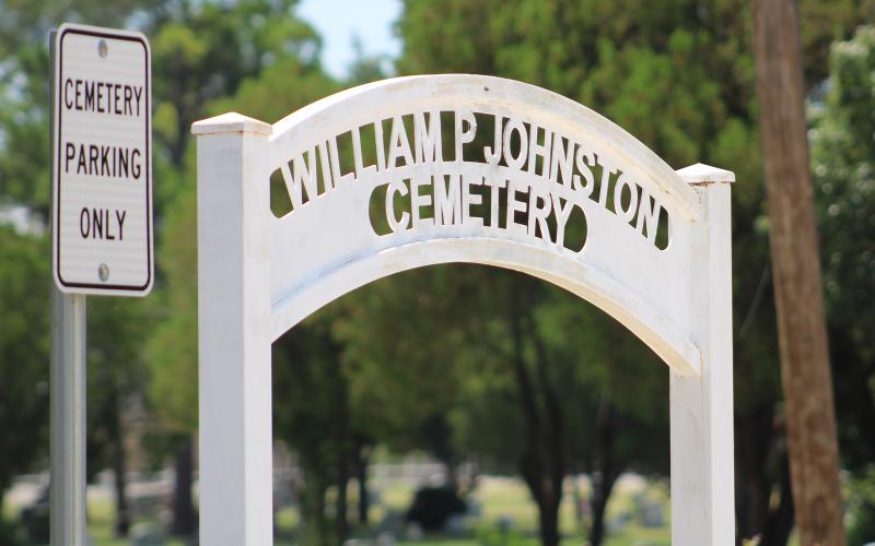 (ALEX HAVARDANSKY | THE GRAHAM LEADER) A sign at the Oak Grove Colored-William P. Johnston Cemetery that was part of new fencing put in by the Young County William P. Johnston Preservation Committee. Old fencing around the cemetery was removed and the fencing received a new coat of paint from Young County 4-H volunteers. 