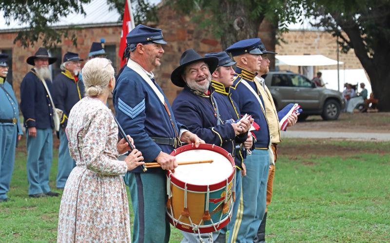 (ARCHIVE PHOTO | THE GRAHAM LEADER) Living history reenactors share a laugh before the flag ceremony at the Fort Belknap Days education event in 2023. The living history event is split up into an education day for students and a public day open to everyone.