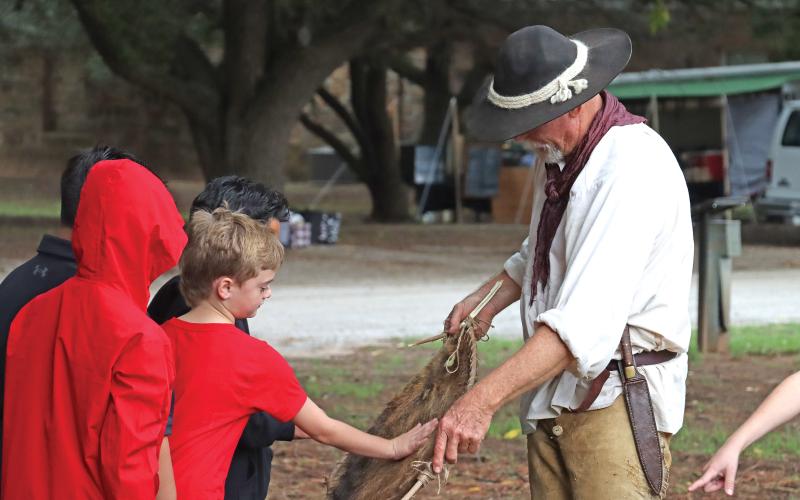 (ARCHIVE PHOTO | THE GRAHAM LEADER) A fur trader reenactor speaks with students from Olney ISD during the education day for Fort Belknap Days in 2023. The living history event features reenactors, vendors and more available on-site for the public day which will be held Saturday, Oct. 26.