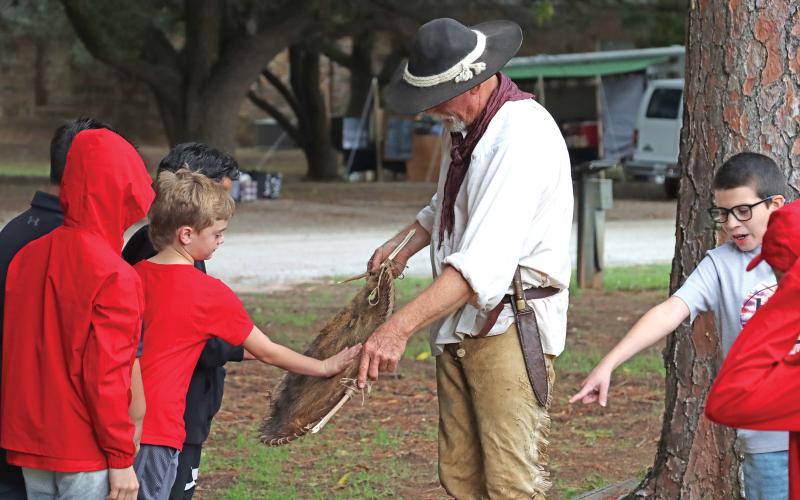 (ARCHIVE PHOTO | THE GRAHAM LEADER) A fur trader reenactor speaks with students from Olney ISD during the education day for Fort Belknap Days in 2023. The living history event features reenactors, vendors and more available on-site for the public day which will be held Saturday, Oct. 25.