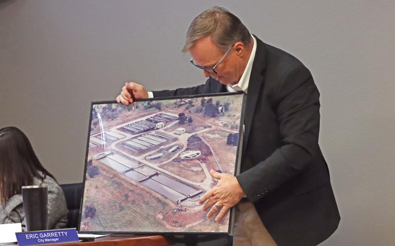 (ARCHIVE PHOTO | THE GRAHAM LEADER) City Manager Eric Garretty shows a photo of a portion of the wastewater treatment plant with the Graham City Council and community Jan. 23, 2025. During that meeting the city approved hiring Freese and Nichols as engineers to plan improvements at the facility.