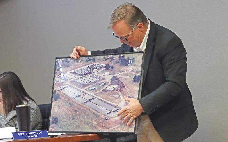 (KYLIE BAILEY | THE GRAHAM LEADER) City Manager Eric Garretty discusses portions of the wastewater treatment plant to the Graham City Council and community watching their meeting Thursday, Jan. 23. The city approved to hire Freese and Nichols as engineers to plan improvements at the facility.