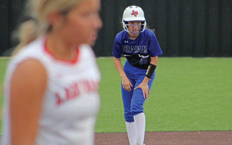 (ALEX HAVARDANSKY | THE GRAHAM LEADER) Tiffany Cotter looks to steal third base Friday, April 18 against the Mineral Wells Lady Rams. Cotter was voted a first team All-District shortstop for the Lady Blues.