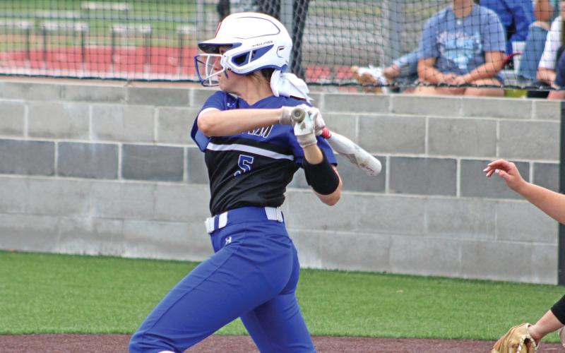 (ALEX HAVARDANSKY | THE GRAHAM LEADER) Hadleigh Allen takes a swing at a pitch Friday, April 18 against the Mineral Wells Lady Rams. Allen was voted as a first team All-District outfielder for the Lady Blues predominantly spending her time in center field.