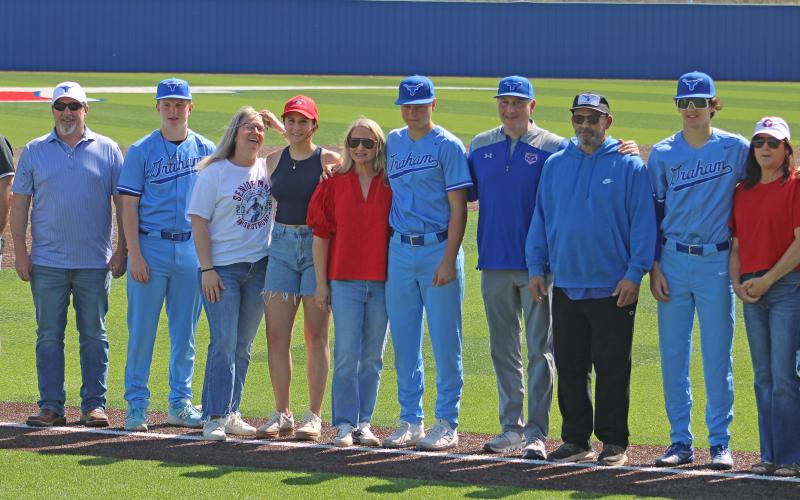 (ALEX HAVARDANSKY | THE GRAHAM LEADER) Milton standing alongside Harison Brockway and Bruin Wright as they are honored with their families at senior day.