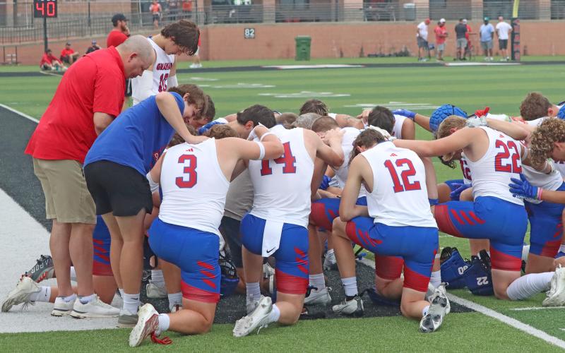 (TC GORDON | THE GRAHAM LEADER) The Graham Steers huddle and give a moment of prayer before one of their games at the Mineral Wells 7on7 state qualifying tournament last Saturday, May 25. The Steers went 3-0 on the day to keep their record perfect through two SQTs.