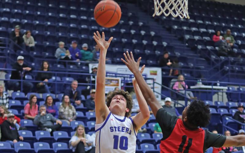 (THOMAS WALLNER | THE GRAHAM LEADER) Brodie Martin of the Steers jumps to put points on the board during the matchup Friday, Jan. 17 against the Mineral Wells Rams. Martin was a key player for the team during the match and has been an asset all season.