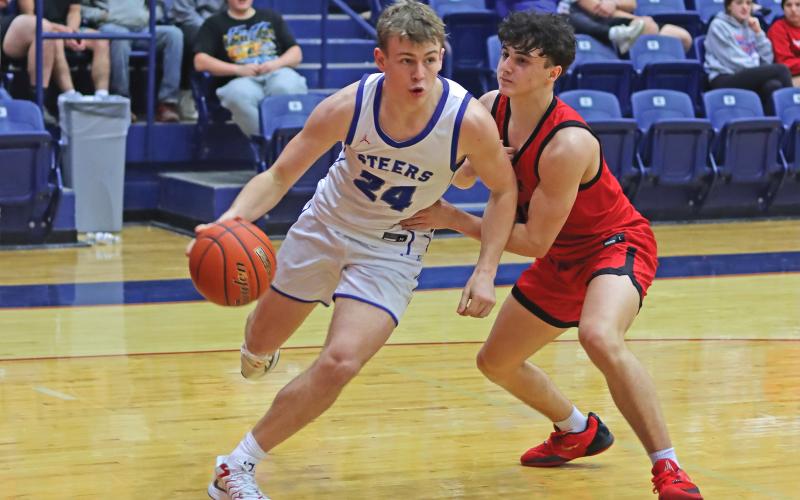 (THOMAS WALLNER | THE GRAHAM LEADER) Thomason Burkett drives the ball to make a play at the basket during a Friday, Jan. 17 matchup against Mineral Wells. After a home game Tuesday, Jan. 21 against Glen Rose, the team will travel Friday, Jan. 24 to face Stephenville. 