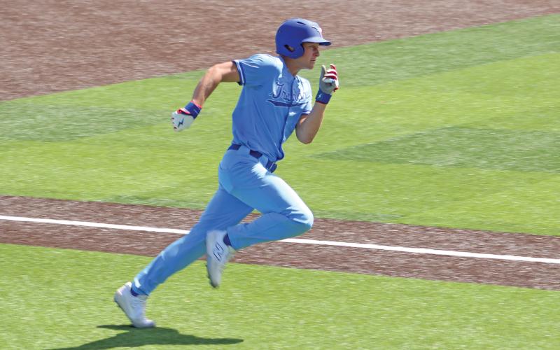 (ALEX HAVARDANSKY | THE GRAHAM LEADER) Harison Brockway races to home plate to score the opening run Saturday, March 22.
