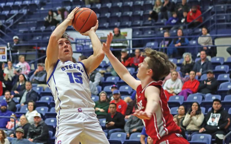 (THOMAS WALLNER | THE GRAHAM LEADER) Ty Thompson jumps over a Glen Rose player to make a shot during a game earlier in the season. Thompson was named Most Valuable Player for the Steers team.