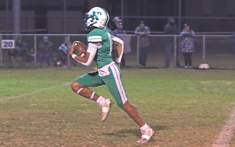 (ARCHIVE PHOTO | THE GRAHAM LEADER) London Martinez races by defenders into the open field. Martinez serves the team as a hybrid back playing both the quarterback and running back positions.