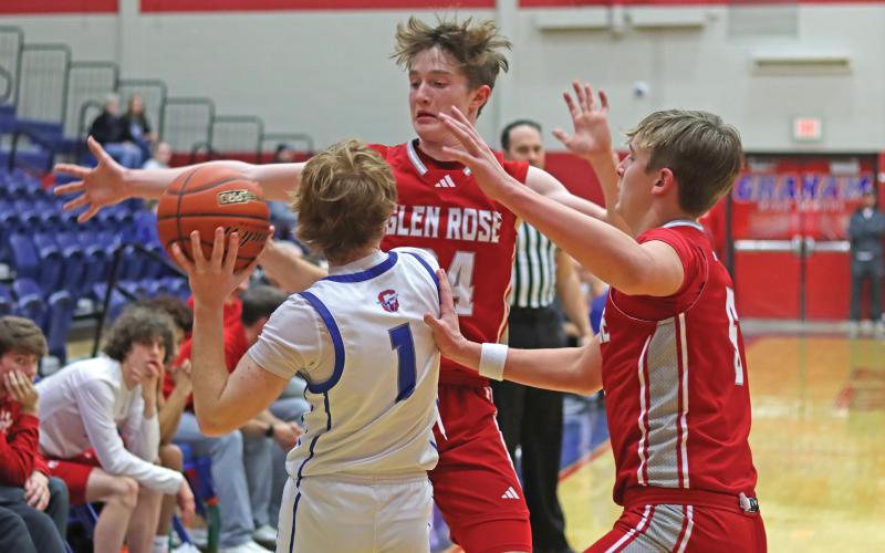 (THOMAS WALLNER | THE GRAHAM LEADER) Tyler Allen fights a tight Glen Rose defense to pass to a teammate Tuesday, Jan. 21.