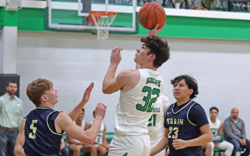 (THOMAS WALLNER | THE GRAHAM LEADER) Cooper Clayton attempts a shot at the net over Perrin defenders during the game Friday, Jan. 24. The Bobcats will travel Tuesday, Jan. 28 to Bryson and will make another trip Friday, Jan. 31 when they go up against Garner. 