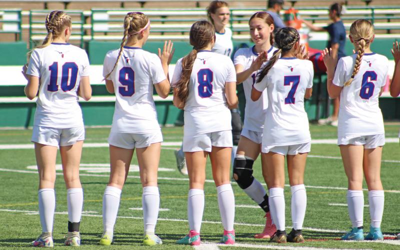(ALEX HAVARDANSKY | THE GRAHAM LEADER) Ellie Weatherman, Brianna Hernandez, Kinsley Amburn, Ava Street, Mylee Lattimore and Marisa Bueno line up during player introductions for their playoff matchup against Lubbock Liberty held Tuesday March, 25. 