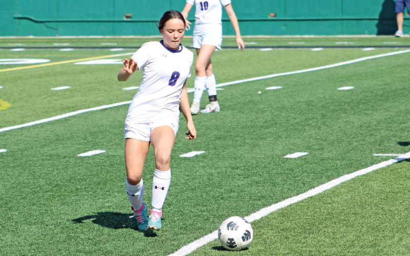 (ALEX HAVARDANSKY | THE GRAHAM LEADER) Kinsley Amburn attempts to clear the ball out of Graham’s zone and away from the Lubbock Liberty Lady Patriots in the first half of their match Tuesday, March 25. The Lady Blues were pressured early by the Lady Patriots.