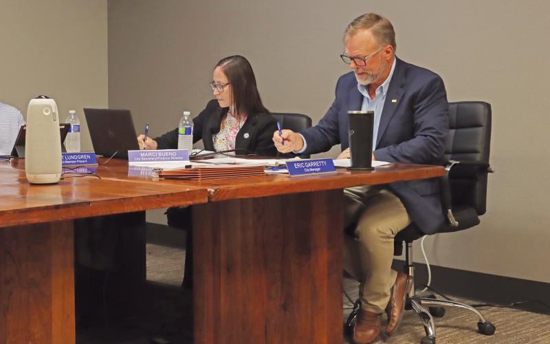 (THOMAS WALLNER | THE GRAHAM LEADER) City Manager Eric Garretty marks the votes made individually by the Graham City Council members for the adoption of a new tax rate. The council adopted a tax rate increase following a public hearing Monday, Sept. 9.