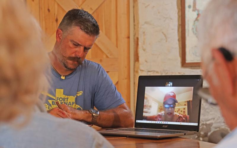 (THOMAS WALLNER | THE GRAHAM LEADER) Young County Historical Commission Chair Jim Hammond writes notes while listening to a presentation from Vanessa Sims regarding a Historic Texas Cemetery medallion.