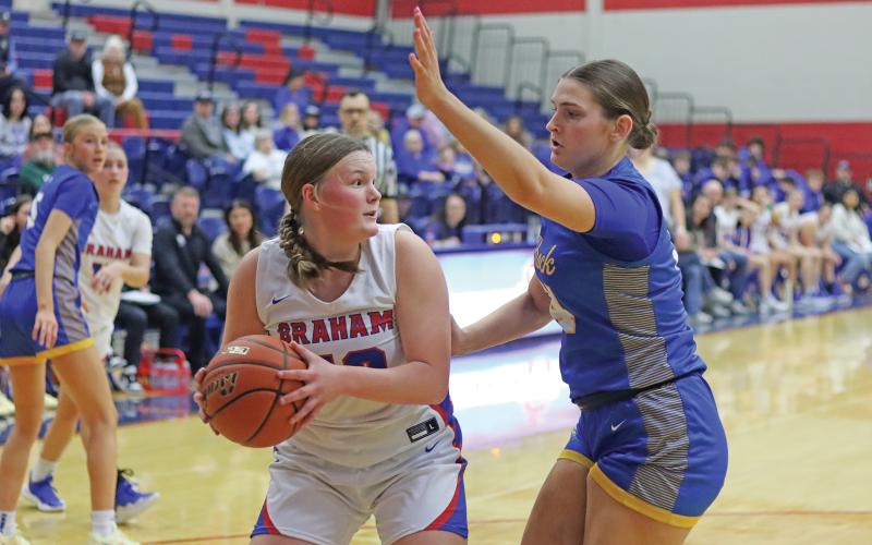 (LIAM BAILEY | THE GRAHAM LEADER) Addyson Weaver looks for an open teammate while being blocked by a Brock defender Tuesday, Jan. 28. While the team improved it is rematch against Brock, it fell 26-46 in the home matchup.