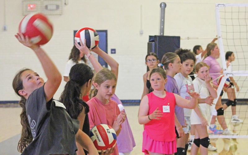 (ALEX HAVARDANSKY | THE GRAHAM LEADER) Lady Blues sixth and seventh grade campers work on their serving form during volleyball camp Tuesday, July 29. Volleyball head coach Marci Faulk said that the younger grade athletes worked on more basic skills like correct serving form. 