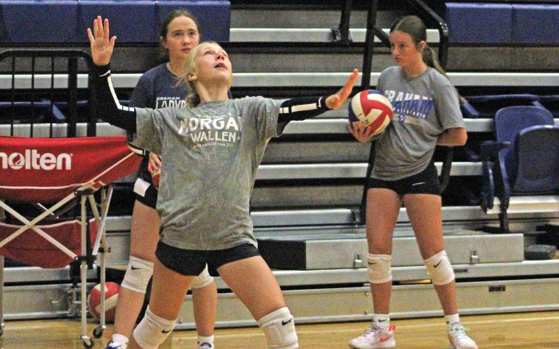 (ALEX HAVARDANSKY | THE GRAHAM LEADER) The Lady Blues eighth and ninth grade campers work on precision serving Tuesday, July 29 at volleyball camp. Faulk said that campers in the eighth and ninth grade sections worked on basic skills but also how to apply them to in game situations.