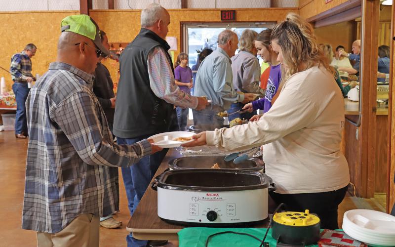 (ARCHIVE PHOTO | THE GRAHAM LEADER) A visitor to the Bethel Baptist Church community Thanksgiving meal in 2023 receives a plate of food from a volunteer. The event this year will be held at noon Thursday, Nov. 28 at the church located at 209 Tennessee St.