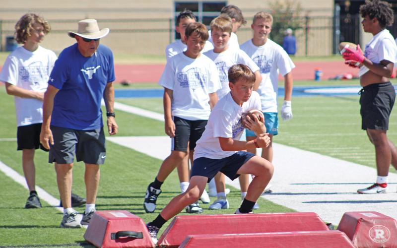 (ALEX HAVARDANSKY | THE GRAHAM LEADER) Steers football campers work on cutting upfield as a runningback Wednesday, July 30. Steers head coach Clay McChristian said that the older kids session focused on specific assigned positions based on player strengths. 