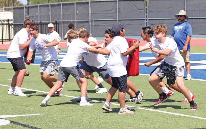 (ALEX HAVARDANSKY | THE GRAHAM LEADER) Steers football campers practice blocking on the offensive line Wednesday, July 30. The camp ran from Monday, July 28, to Wednesday, July 30. 