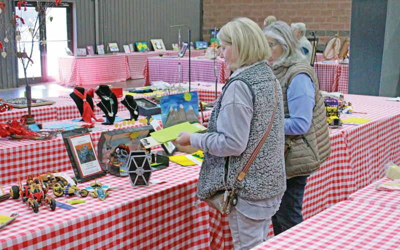 (ARCHIVE PHOTO | THE GRAHAM LEADER) Judges Kimberly Birdwell and Lynee Powell look over entries in the Creative Arts Contest which was held with the Young County Junior Livestock Show and County Fair at the Young County Arena in January 2024. 