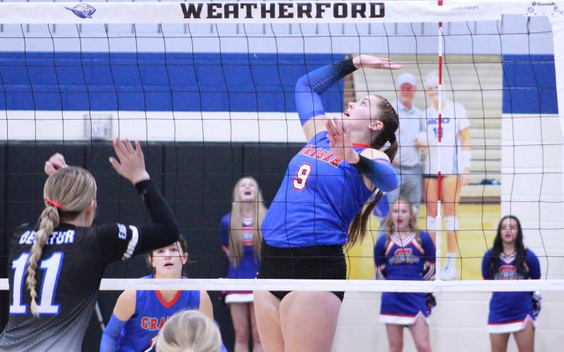 (TC GORDON | THE GRAHAM LEADER) Junior Annemarie McHenry jumps into the air and prepares to hit the ball for a potential kill during Graham’s area round matchup Friday, Nov. 11 against Decatur. The Lady Blues lost to the Lady Eagles in three sets and their season is over.
