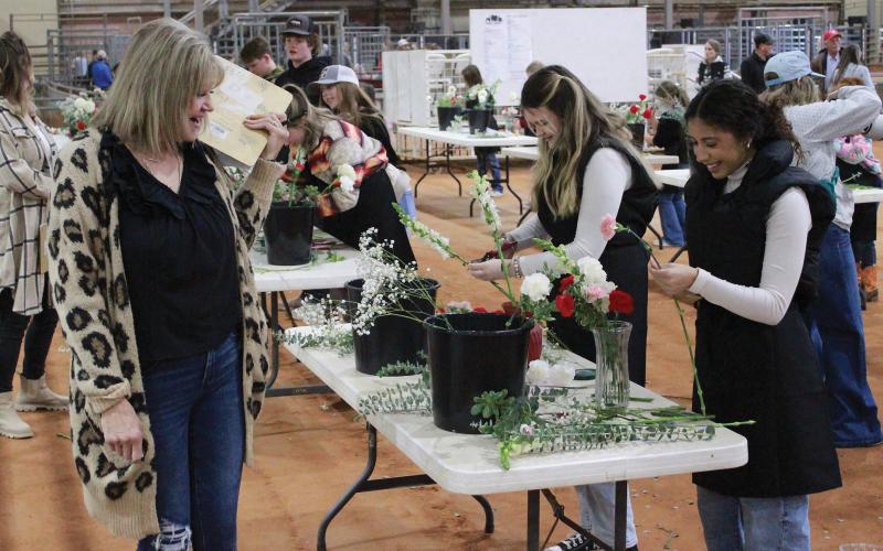 (ARCHIVE PHOTO | THE GRAHAM LEADER) Participants in the Floral Design Contest arrange entries at the Young County Arena in January 2024. The competition this year will be held Thursday, Jan. 15 at the Young County Arena. 