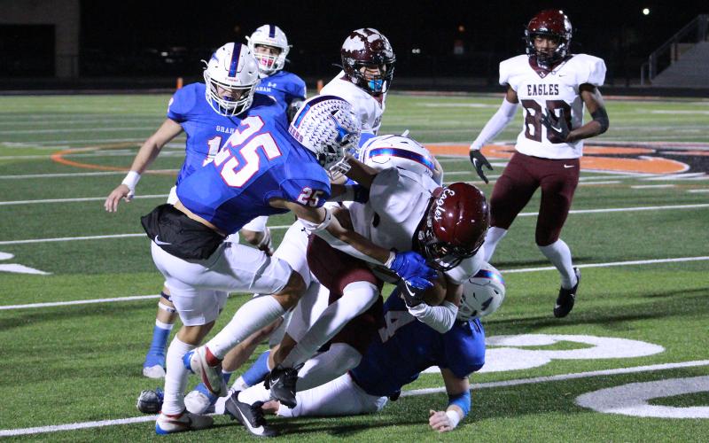 (TC GORDON | THE GRAHAM LEADER) A trio of Graham defenders work together to bring down a Hillsboro ball handler during the Steers’ 56-0 bi-district championship win over the Eagles Friday, Nov. 10.