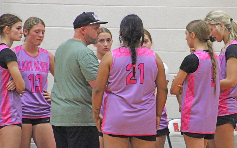 (ALEX HAVARDANSKY | THE GRAHAM LEADER) The Lady Blues discussed game strategy with head coach Brian Nail in their matchup Thursday, May 1 against the Huckabay Lady Indians. Nail said after the game that he liked the fight his team showed throughout the night.