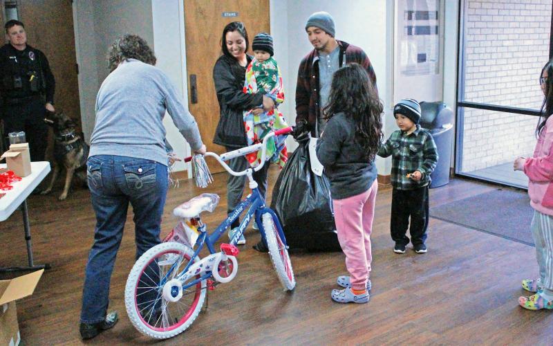 (ARCHIVE PHOTO | THE GRAHAM LEADER) Volunteers with Young County Toys for Tots and Graham Police Department officers help distribute gifts at First Baptist Church in Graham. The distribution day for Toys for Tots will be Saturday, Dec. 20 at the church.