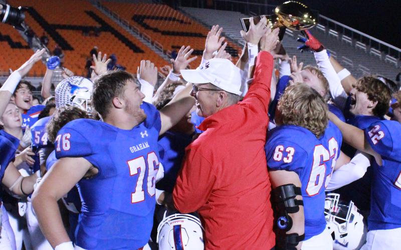(TC GORDON | THE GRAHAM LEADER) Graham High School head football coach Kenny Davidson presents the bi-district championship trophy to his team Friday, Nov. 10 after the Steers defeated the Hillsboro Eagles 56-0. Davidson will be retiring after 19 years with the district.