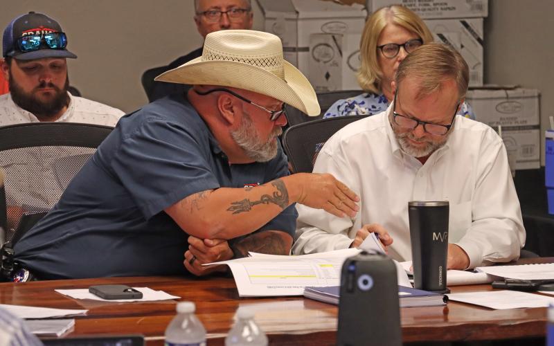 (ARCHIVE PHOTO | THE GRAHAM LEADER) City Manager Eric Garretty (right) and Animal Control Officer Mike Watts look over documents during a meeting of the Graham City Council in 2025. The city council approved Garretty to renegotiate the rate structure to $500 per animal with the Humane Society of Young County.